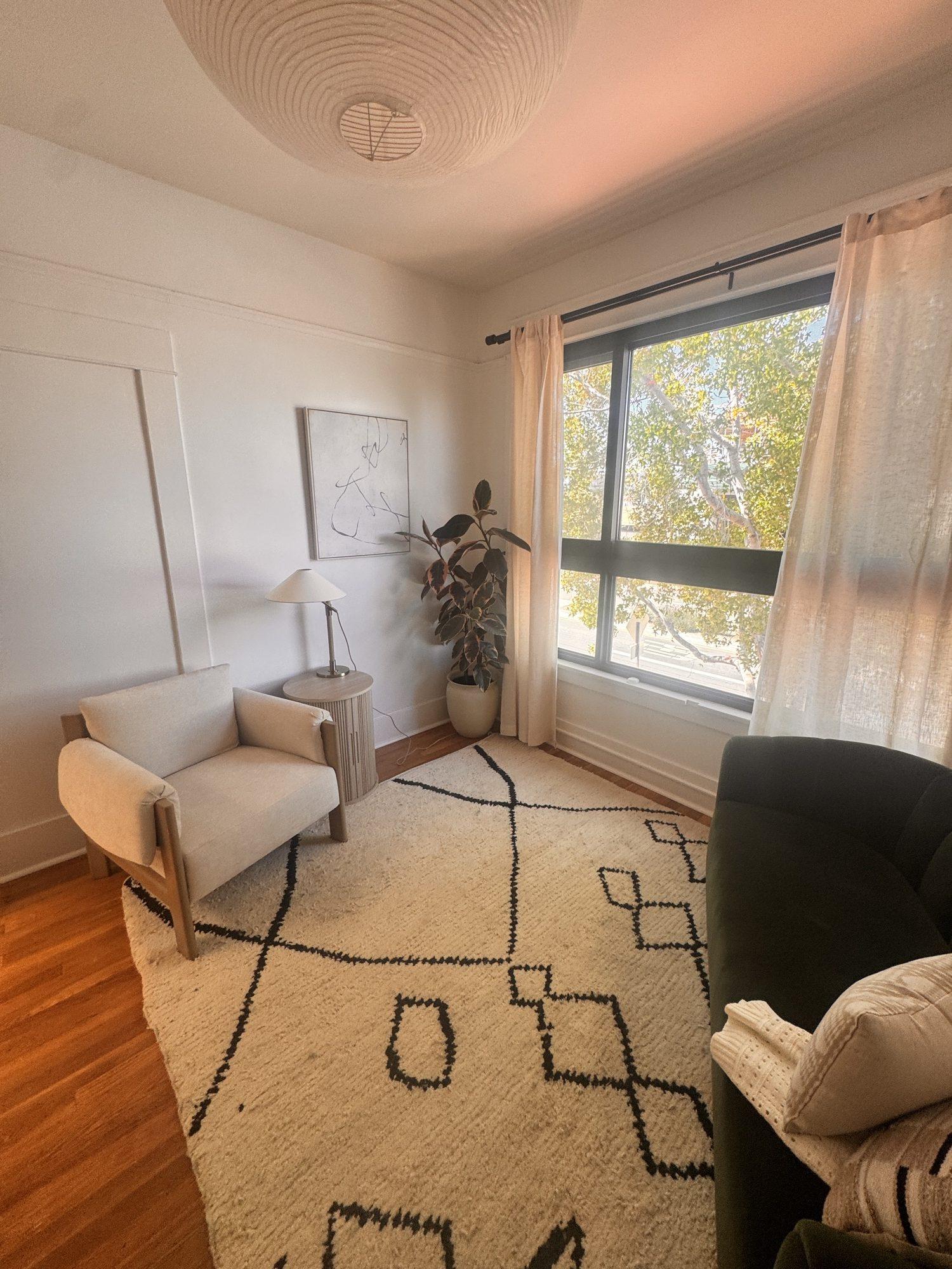 Armchair, lamp and plant by the window in Unit 4